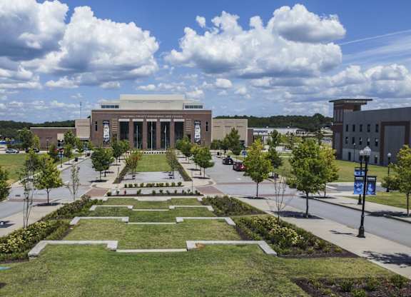 A large building with a long walkway in front of it.