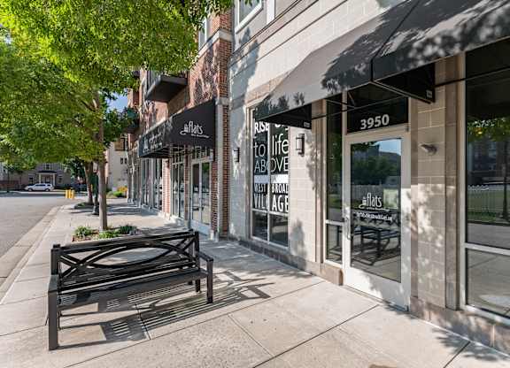 a bench on a sidewalk in front of a building