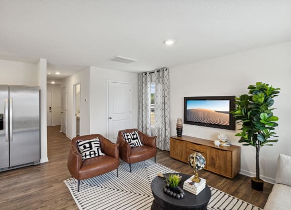 a living room with two chairs and a tv at Summit Place Apartments, Oak Ridge