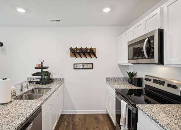 a kitchen with granite counter tops and stainless steel appliances at Summit Place Apartments, Oak Ridge, TN