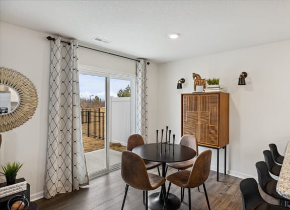 our apartments offer a dining room with a table and chairs and a balcony at Summit Place Apartments, Oak Ridge, Tennessee