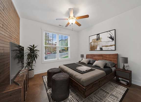 A bedroom with a bed, a ceiling fan, and a window with blinds at Skyloft in North Carolina 28803