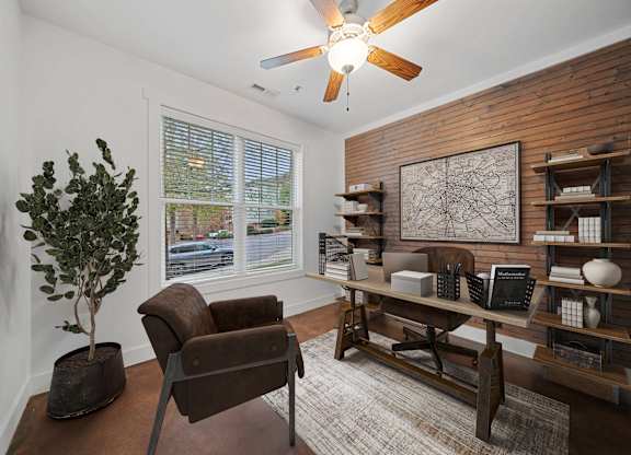 A living room with a brown chair and a tree in a pot at Skyloft in NC 28803
