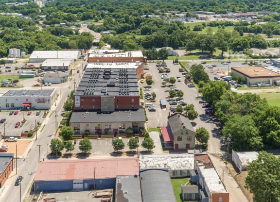 an aerial view of the parking lot and rooftops of buildings in a city at Mayton Transfer Lofts in Petersburg, 23803