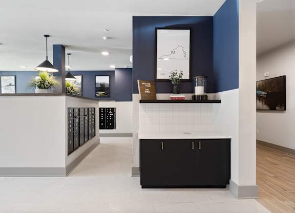 A modern kitchen with black and white cabinets and a white countertop.