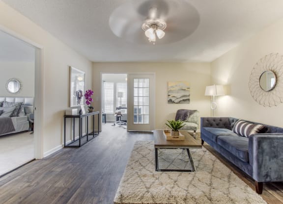 a living room with a couch and a coffee table at Abbington Place Apartments, Greensboro , NC