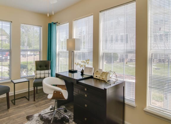 a home office with a desk and chairs and large windows at Abbington Place Apartments, Greensboro , NC 27407