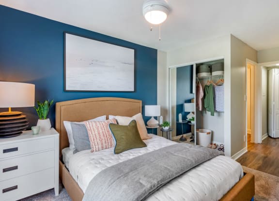 a bedroom with a bed and a blue wall and a closet at The Villas at Ibis Landing, Parkland, Florida