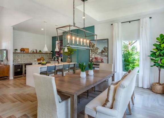 a dining room and kitchen with a wooden table and chairs at The Villas at Ibis Landing, Florida
