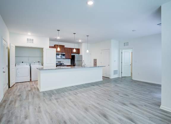 A kitchen with white appliances and a white countertop.