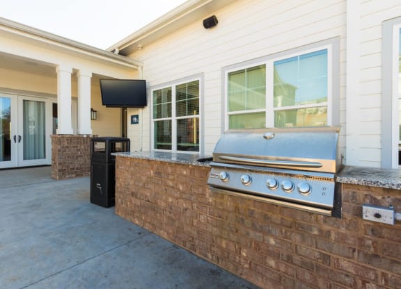 a covered patio with a barbecue grill on it at Capstone at Banks Crossing, Commerce, GA, 30529
