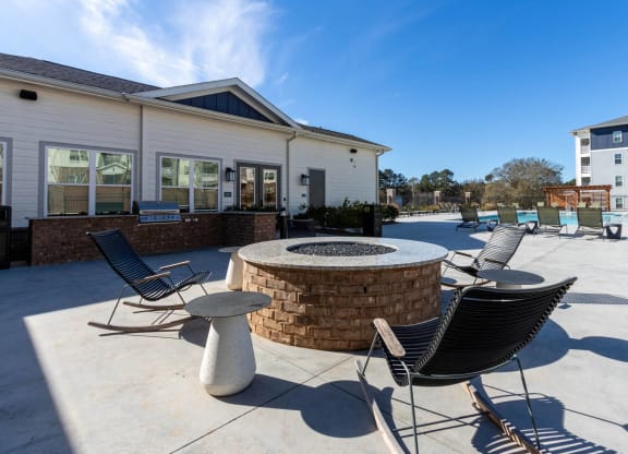 our patio has a fire pit and seating area with chairs and tables at Capstone at Banks Crossing, Commerce, 30529