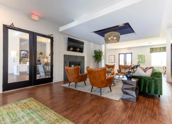 a living room with a fireplace and a green couch at Capstone at Banks Crossing, Georgia