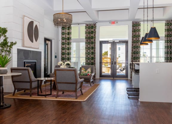 a living room with a fireplace and a table and chairs at Capstone at Banks Crossing, Commerce, GA