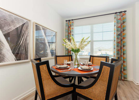 a dining room with a table and chairs and a window at Capstone at Banks Crossing, Commerce, GA