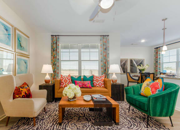 a living room filled with furniture and a window at Capstone at Banks Crossing, Commerce