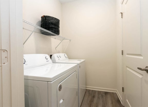 a washer and dryer in a room with a door at Capstone at Banks Crossing, Georgia