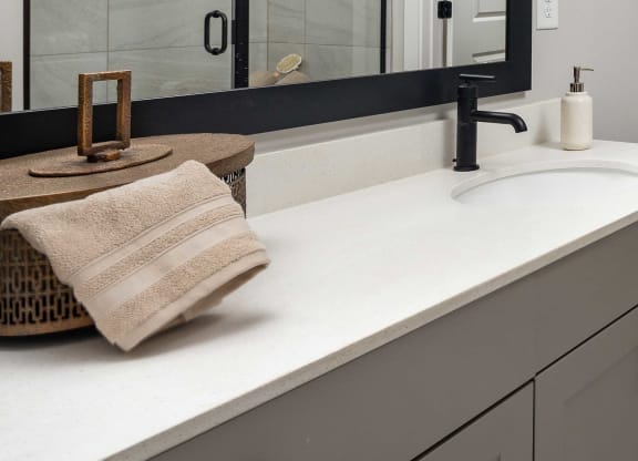 a modern and funky half bathroom reveal with black and white tile in a modern laundry space at The Flats at Southlawn Apartments, Lawrenceville Georgia