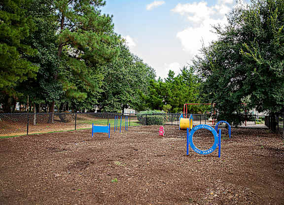 A playground with a blue swing set and a yellow slide.