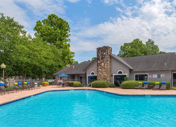 a large swimming pool in front of a house at High Ridge Apartments, Athens Georgia