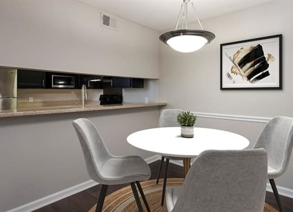 a small dining room with a white table and chairs at High Ridge Apartments, Athens Georgia