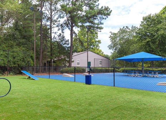 a playground with a tennis court and a swing set at High Ridge Apartments, Athens, GA 30606