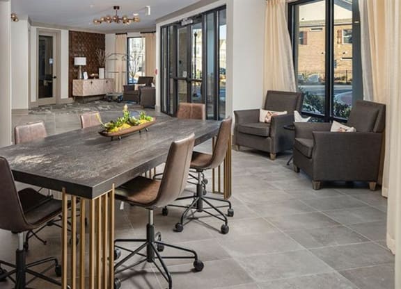a dining room with a table and chairs at The Flats at Southlawn Apartments, Lawrenceville