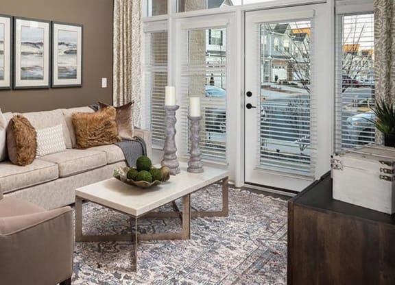 a living room with a couch and a table at The Flats at Southlawn Apartments, Georgia, 30046