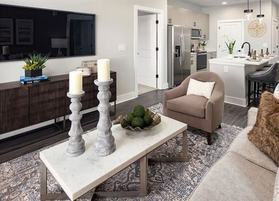 a living room with a couch and a table at The Flats at Southlawn Apartments, Lawrenceville, 30046