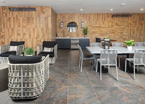 a restaurant with tables and chairs and a kitchen at The Flats at Southlawn Apartments, Georgia, 30046