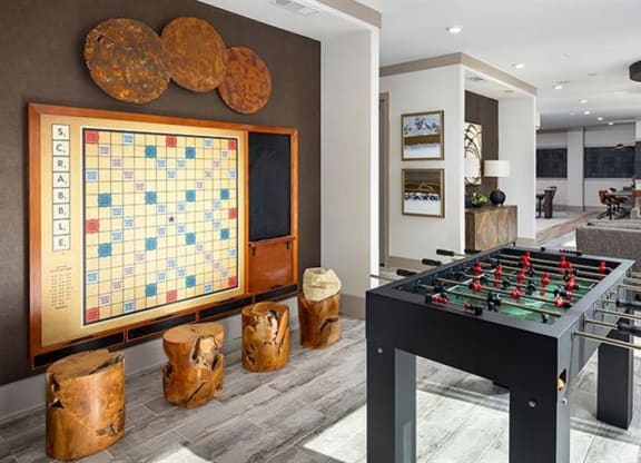 a game room with a foosball table and a board game at The Flats at Southlawn Apartments, Georgia, 30046