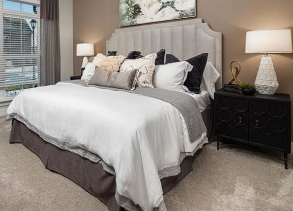 a bedroom with a bed and a window at The Flats at Southlawn Apartments, Georgia