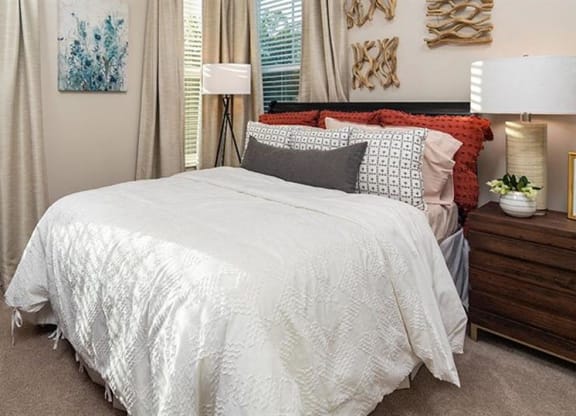 a bedroom with a bed and two windows at Promenade at Newnan Crossing, Newnan Georgia