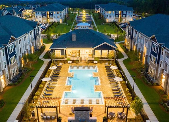 an aerial view of an apartment complex with a large swimming pool at Promenade at Newnan Crossing, Georgia