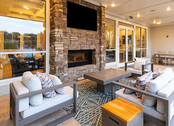 a living room with couches and a large fireplace at Promenade at Newnan Crossing, Newnan Georgia