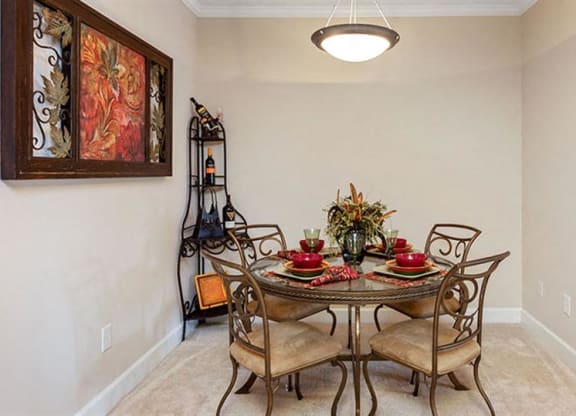 a dining room with a table and chairs at Bedford Parke Apartments, Georgia, 31088