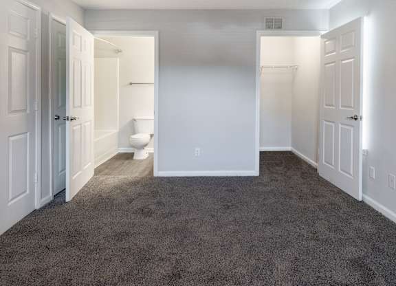 A room with carpeted floor and white walls.