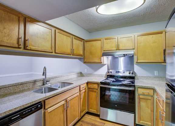 A kitchen with wooden cabinets and stainless steel appliances.