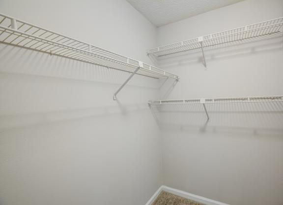 Empty white shelves in a room.