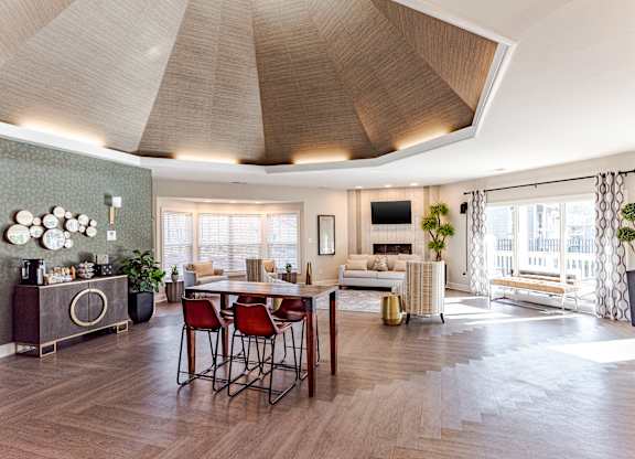 A modern living room with a wooden floor and a large window.