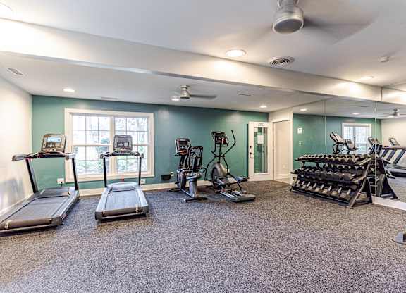 A spacious home gym with a variety of exercise equipment.