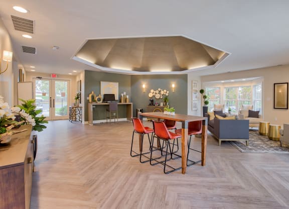a resident clubhouse with a table with four chairs and a couch in the background at Hunters Chase Apartments, Midlothian