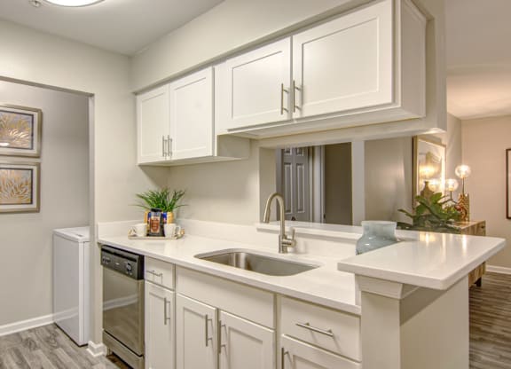 a kitchen with white cabinets and a sink at Hunters Chase Apartments, Midlothian, Virginia