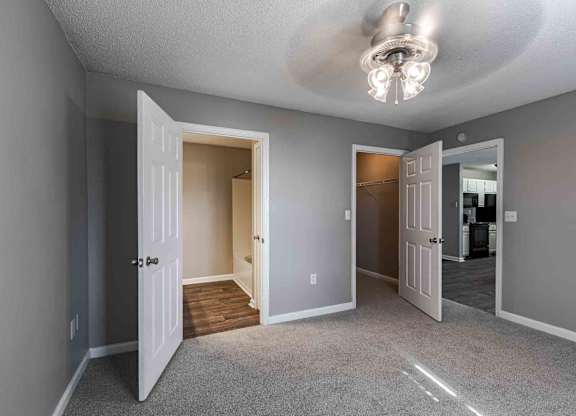 A room with a carpeted floor and a ceiling light.