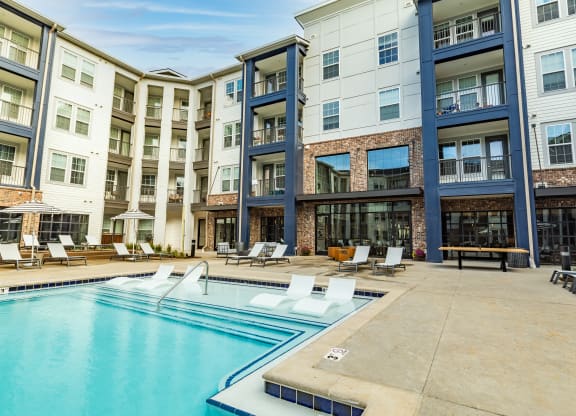 a swimming pool in front of an apartment building at The Louis Apartment Flats, Kentucky