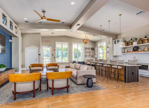 A modern kitchen with a dining area and a living room.