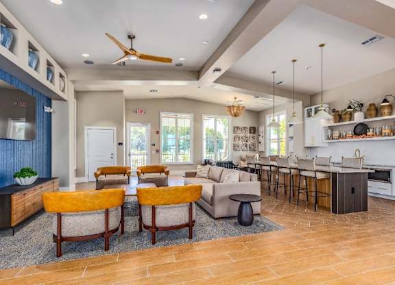 A modern kitchen with a dining area and a living room.