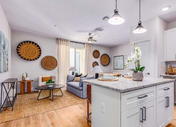 A kitchen with a dining table and chairs in the middle of the room.