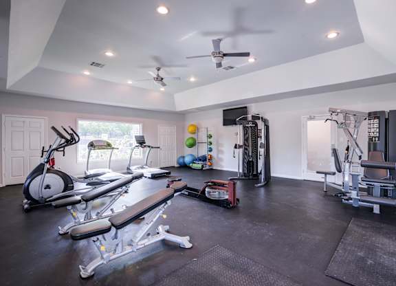 A spacious home gym with a variety of exercise equipment.
