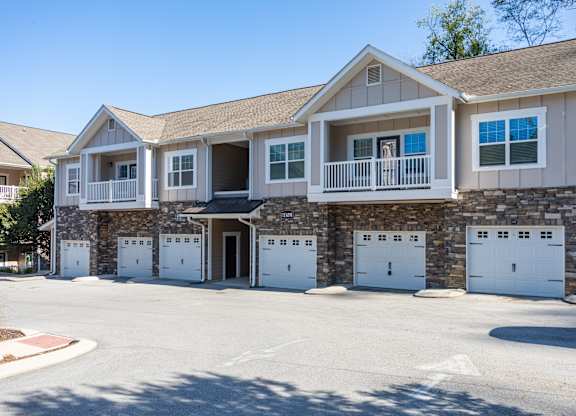A large two-story house with a garage on the ground floor.